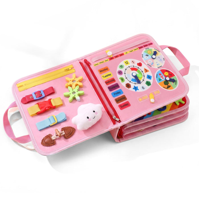 The activity board in pink, open to show buckles, zippers, a clock, days of the week and a plush cloud