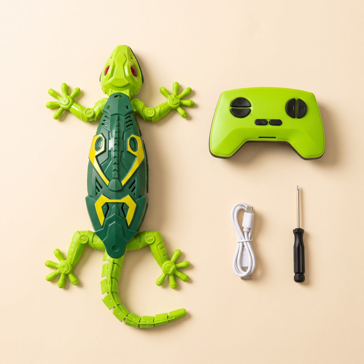 The set laid out: the lizard, its green remote control, a white USB cable and a small screwdriver