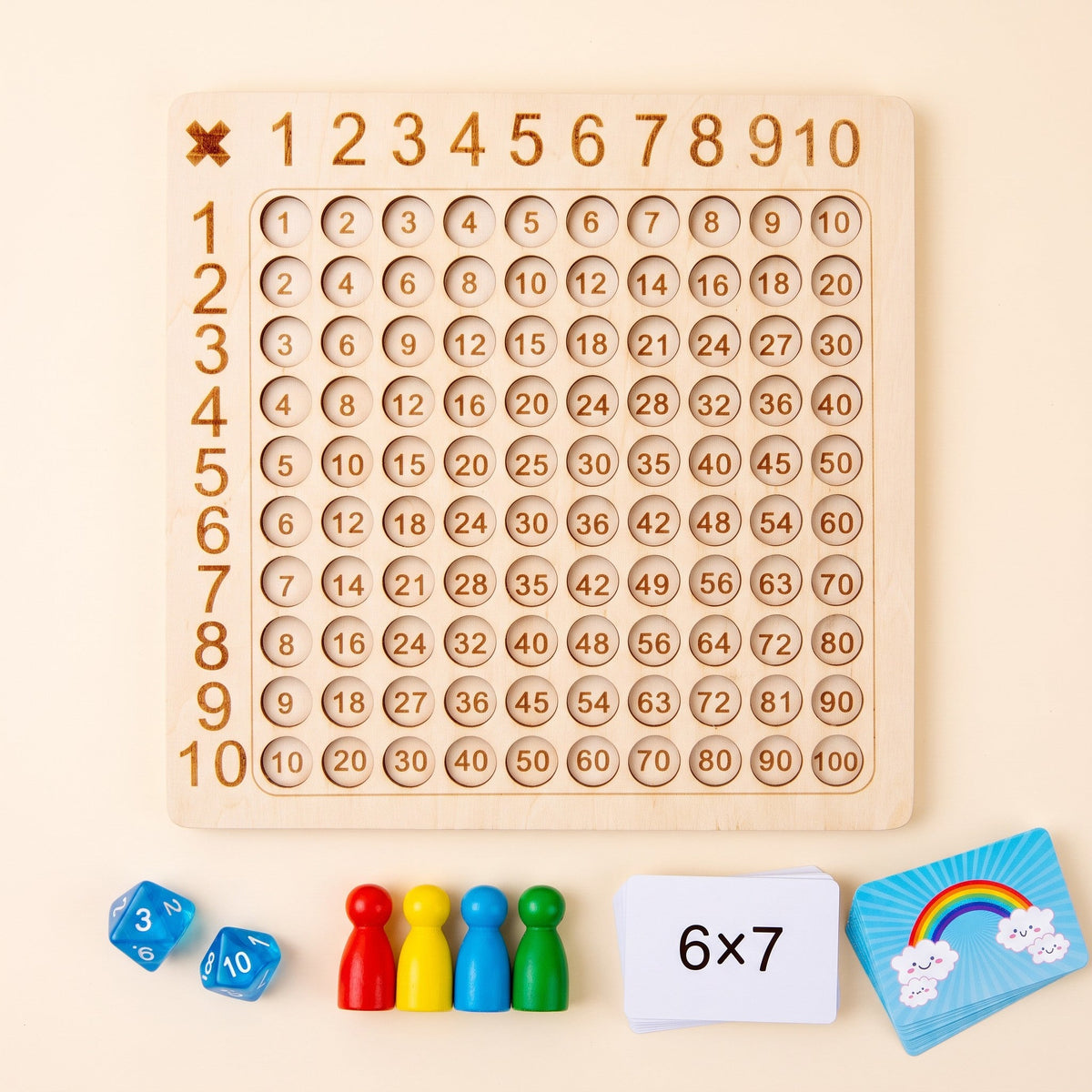 The game laid out: the wooden board, two 10-sided dice, four colored pawns and two card stacks, one showing 6 times 7.