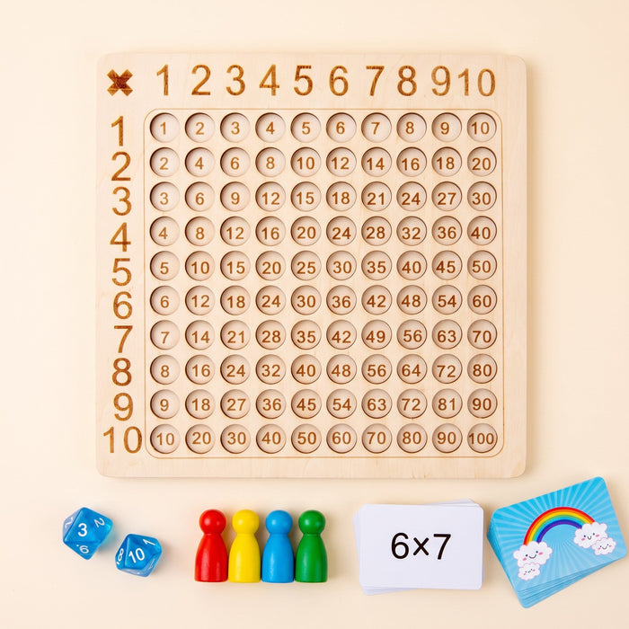 The game laid out: the wooden board, two 10-sided dice, four colored pawns and two card stacks, one showing 6 times 7.