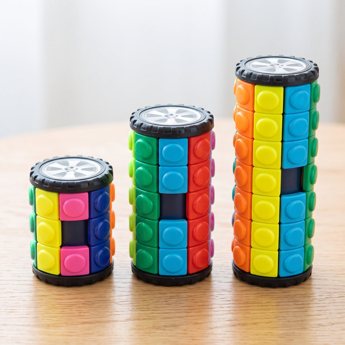 The three puzzles side by side, short to tall, with 3, 5 and 7 rows of color tiles and one empty gap in each