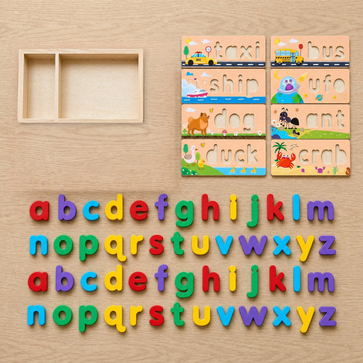 The set laid out: a two-part wooden box, 8 word cards (taxi, bus, ship, UFO, dog, ant, duck, crab) and two a to z alphabets
